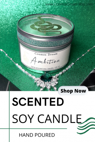 Green Ambition candle, shown with green tie, green background and silver/green jewelry.
