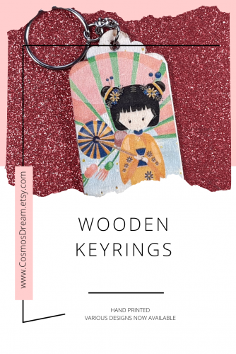 Pinterest pin, wooden keyring with a girl wearing a kimono and carrying a fan artwork on it.